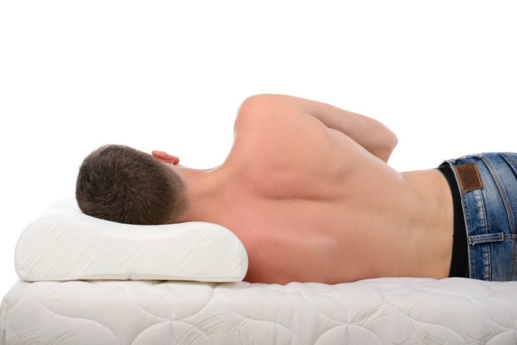 A man laying down on a body contouring mattress.