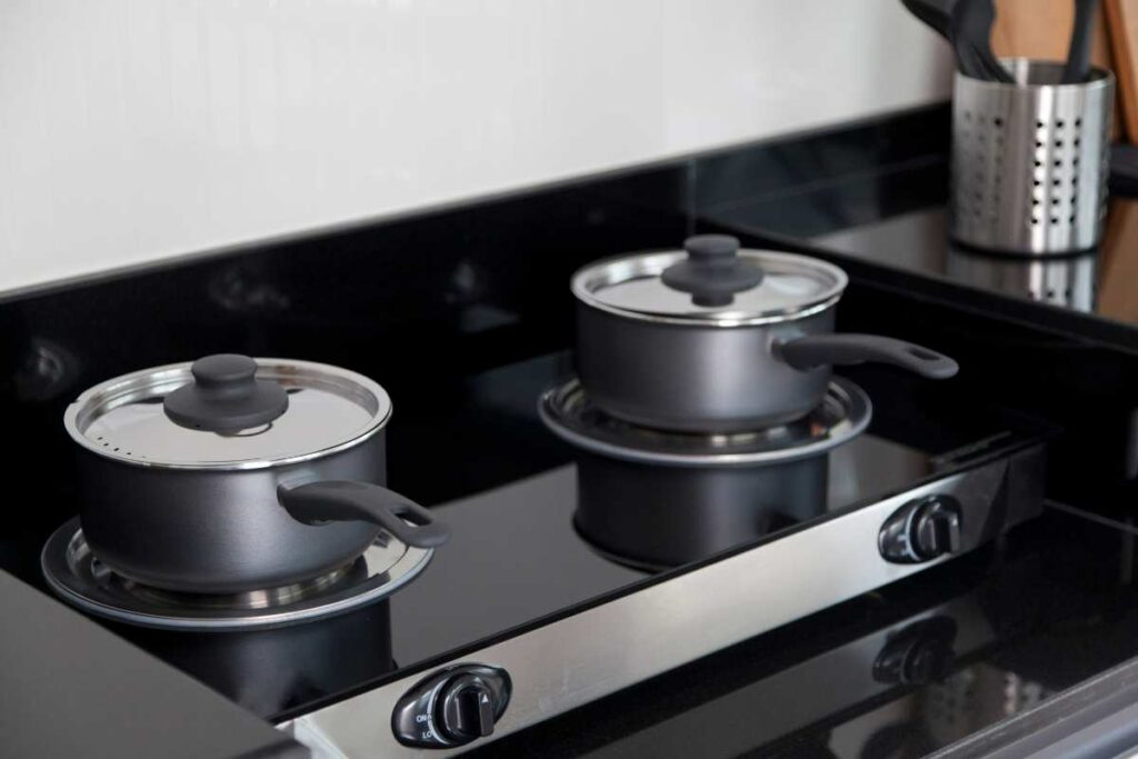 Two pots on glass top gas stove 