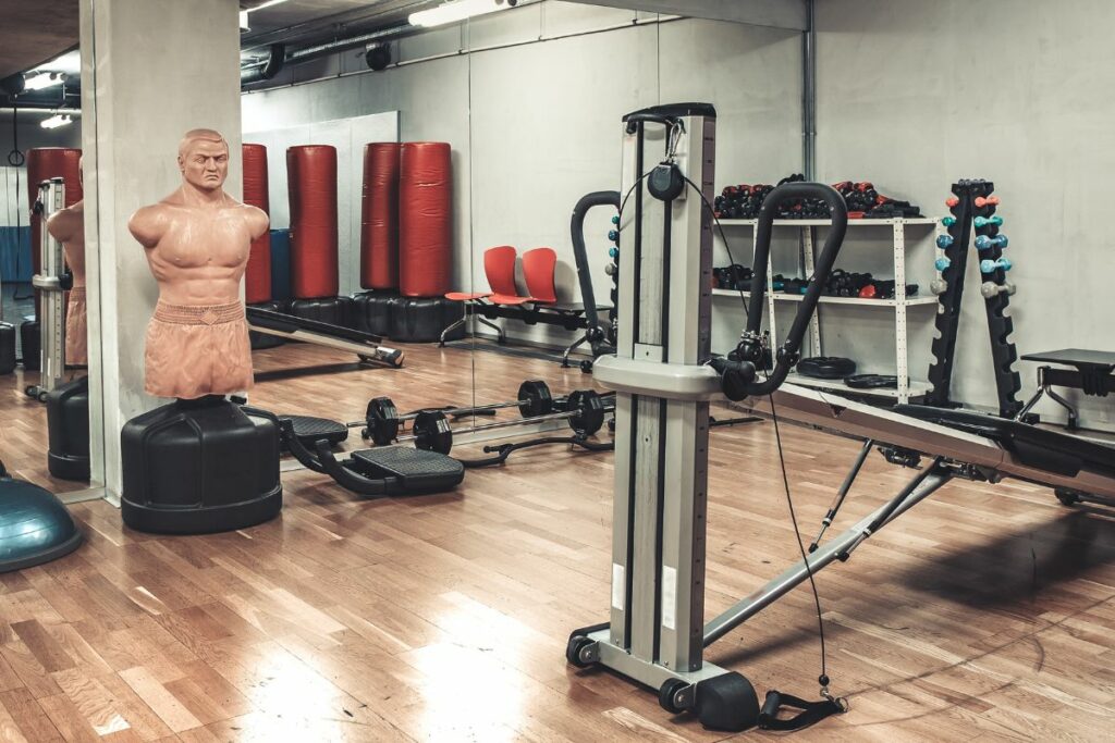 A gym room at Gym Centre with exercise equipment and a mannequin.