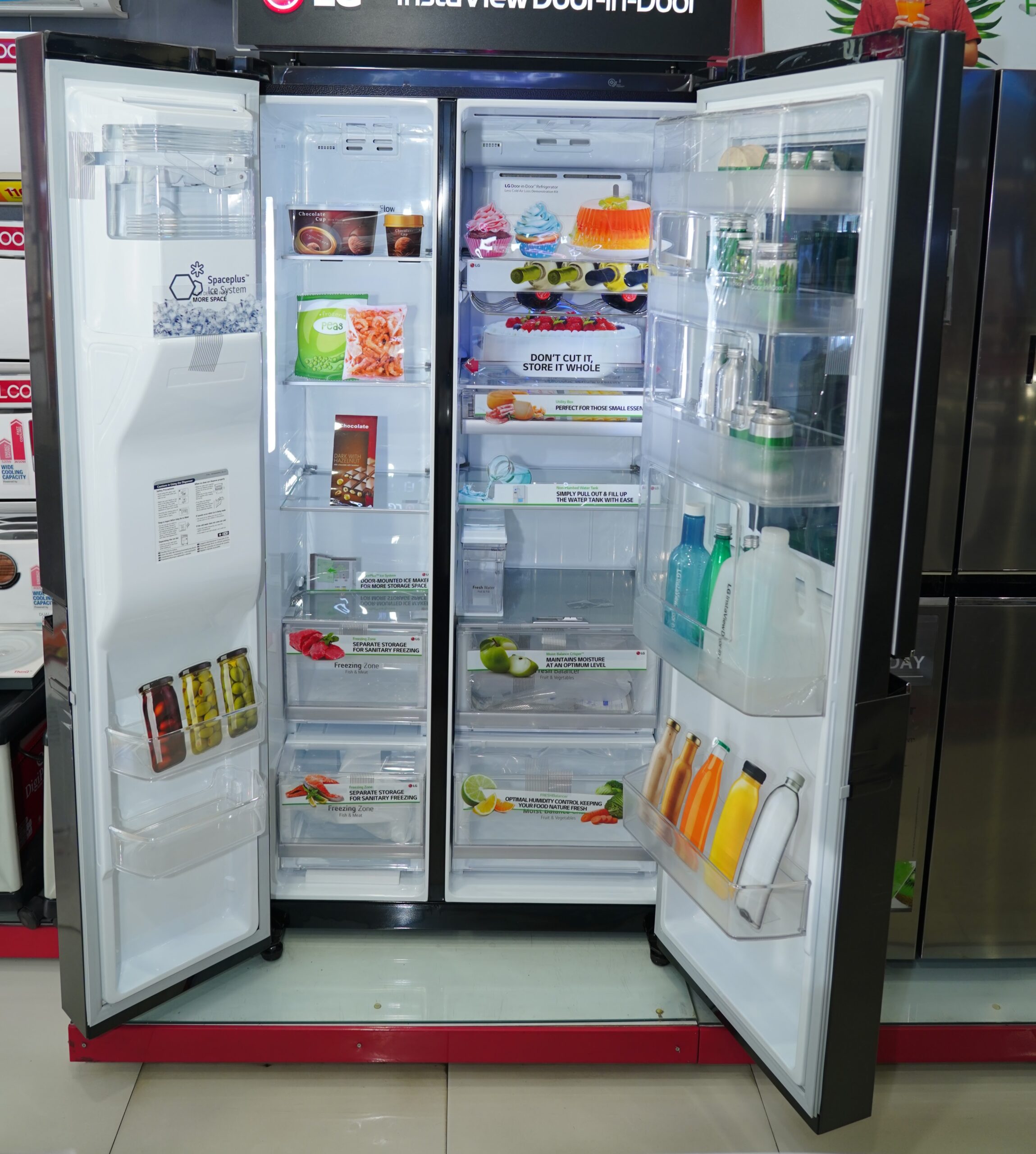 Interior of LG 688 L Frost Free Smart Inverter Side-by-Side Refrigerator: spacious shelves and LED lighting